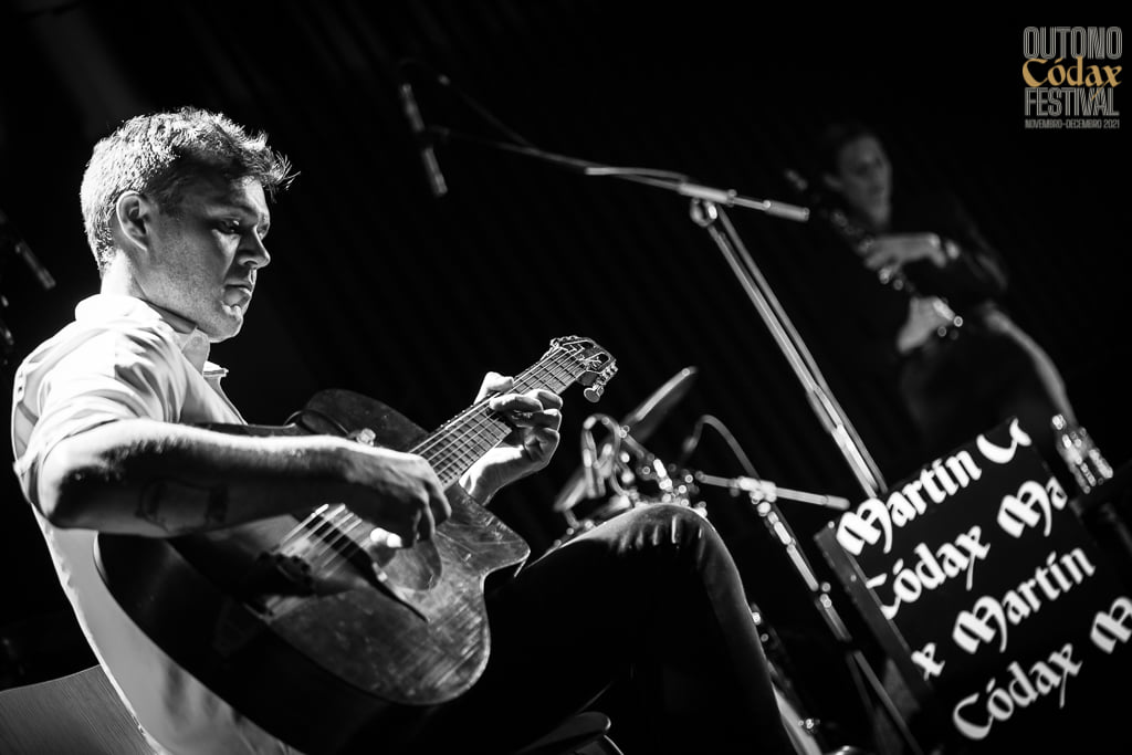 Black and white photo of Leo Forde playing guitar